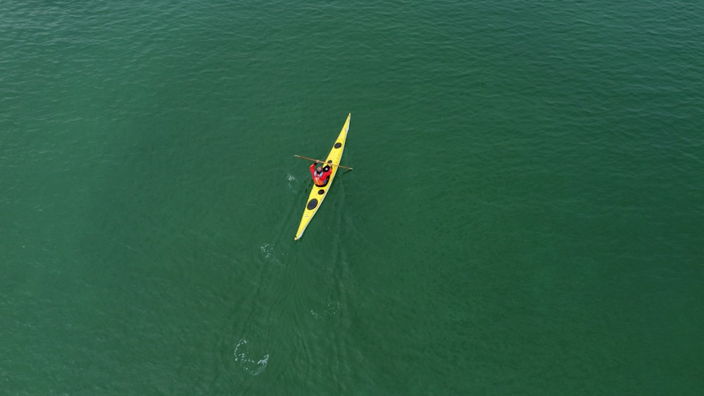 a person in a kayak in the middle of the ocean