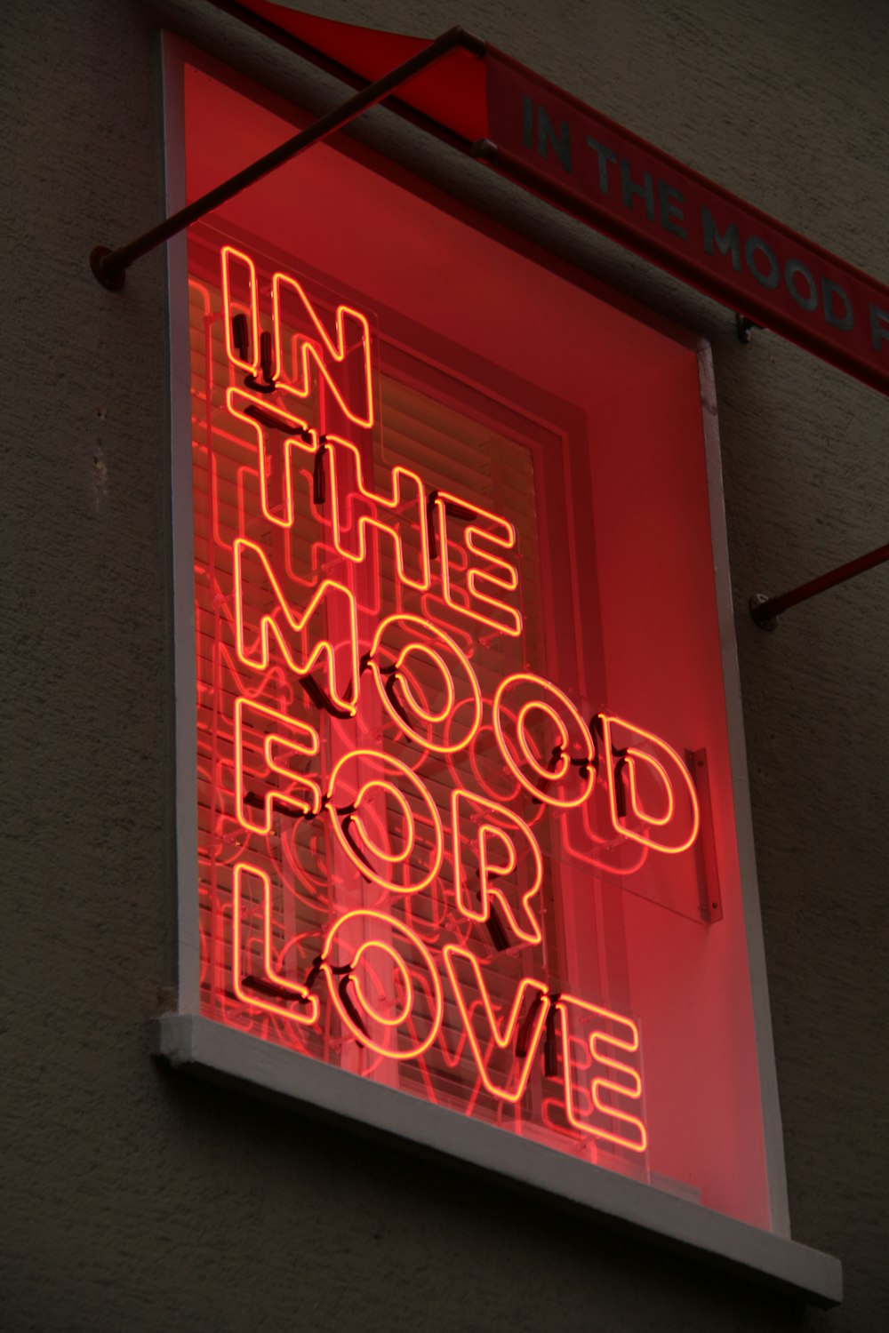 a neon sign that reads in the mood for love