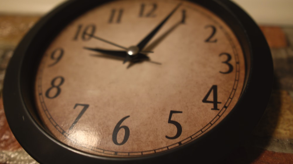 a close up of a clock on a table