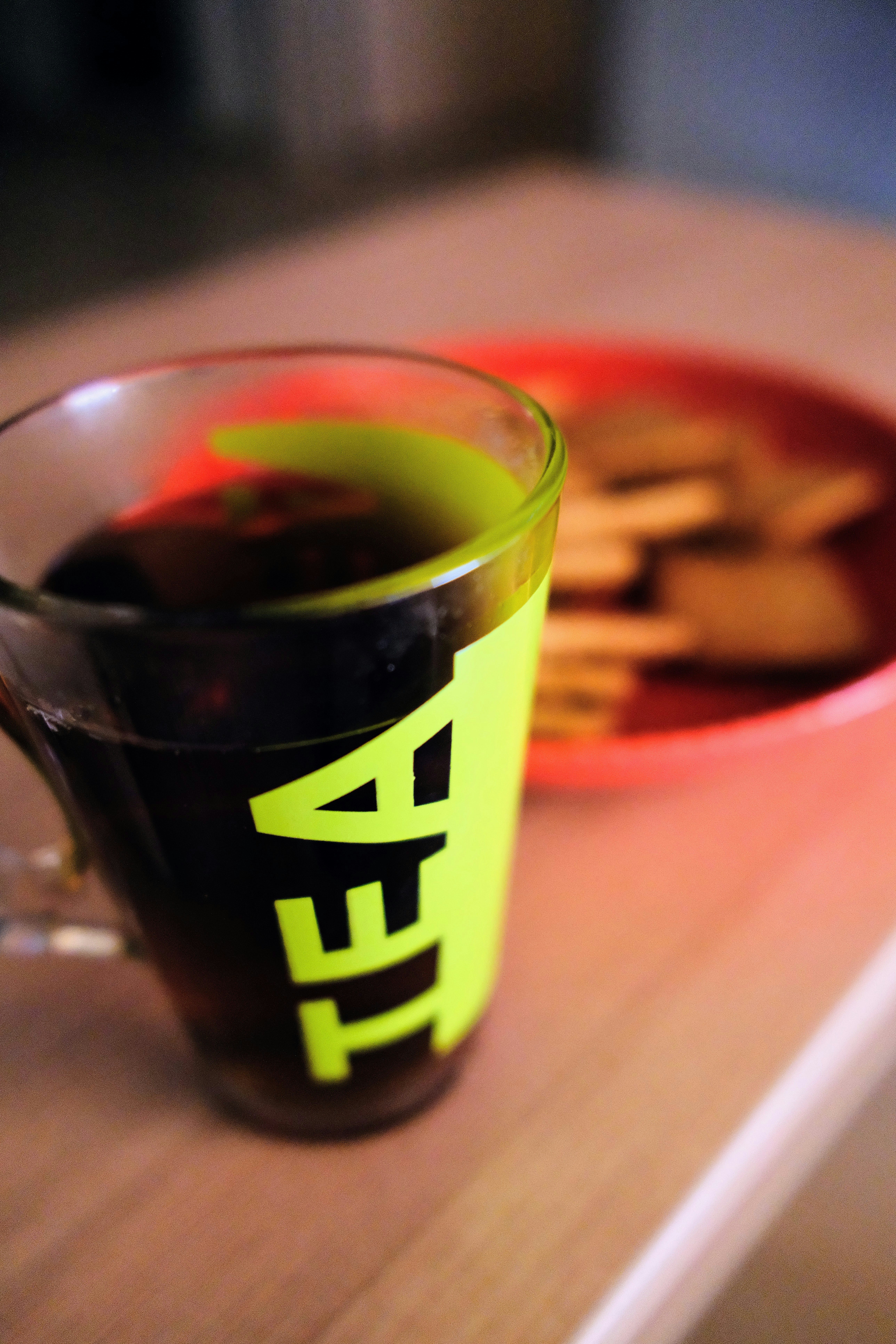 a cup of tea next to a plate of cookies