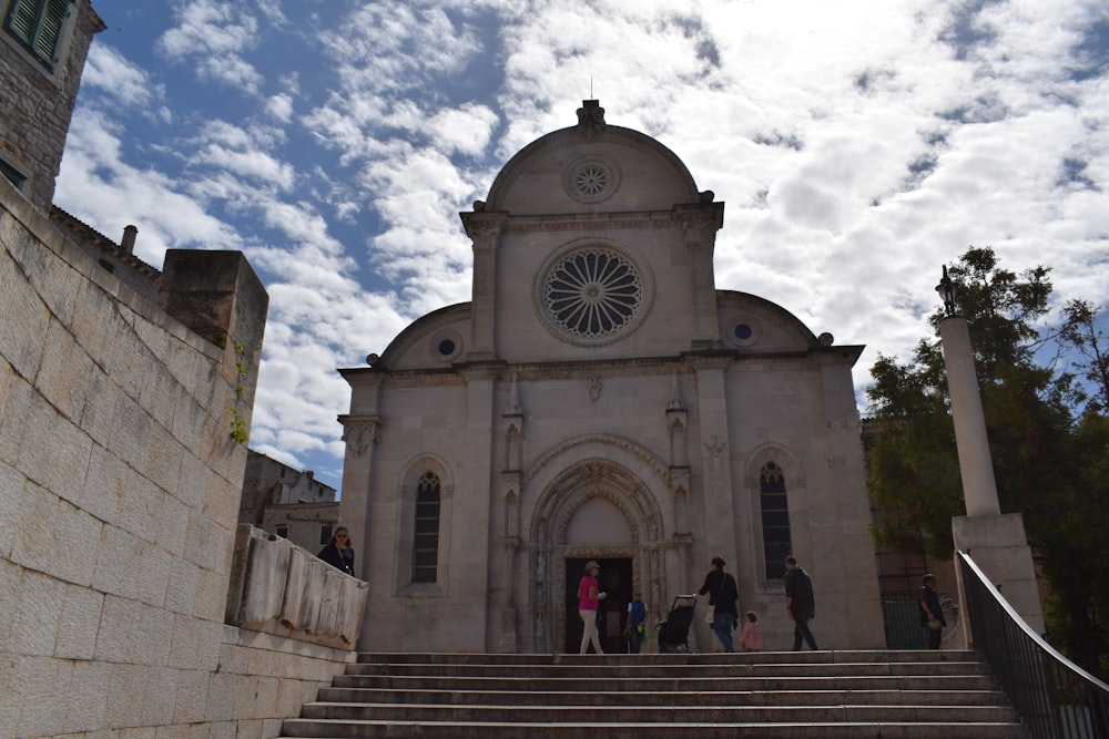 a group of people standing outside of a church