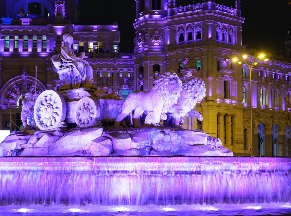 a water fountain with a statue of a lion on top of it