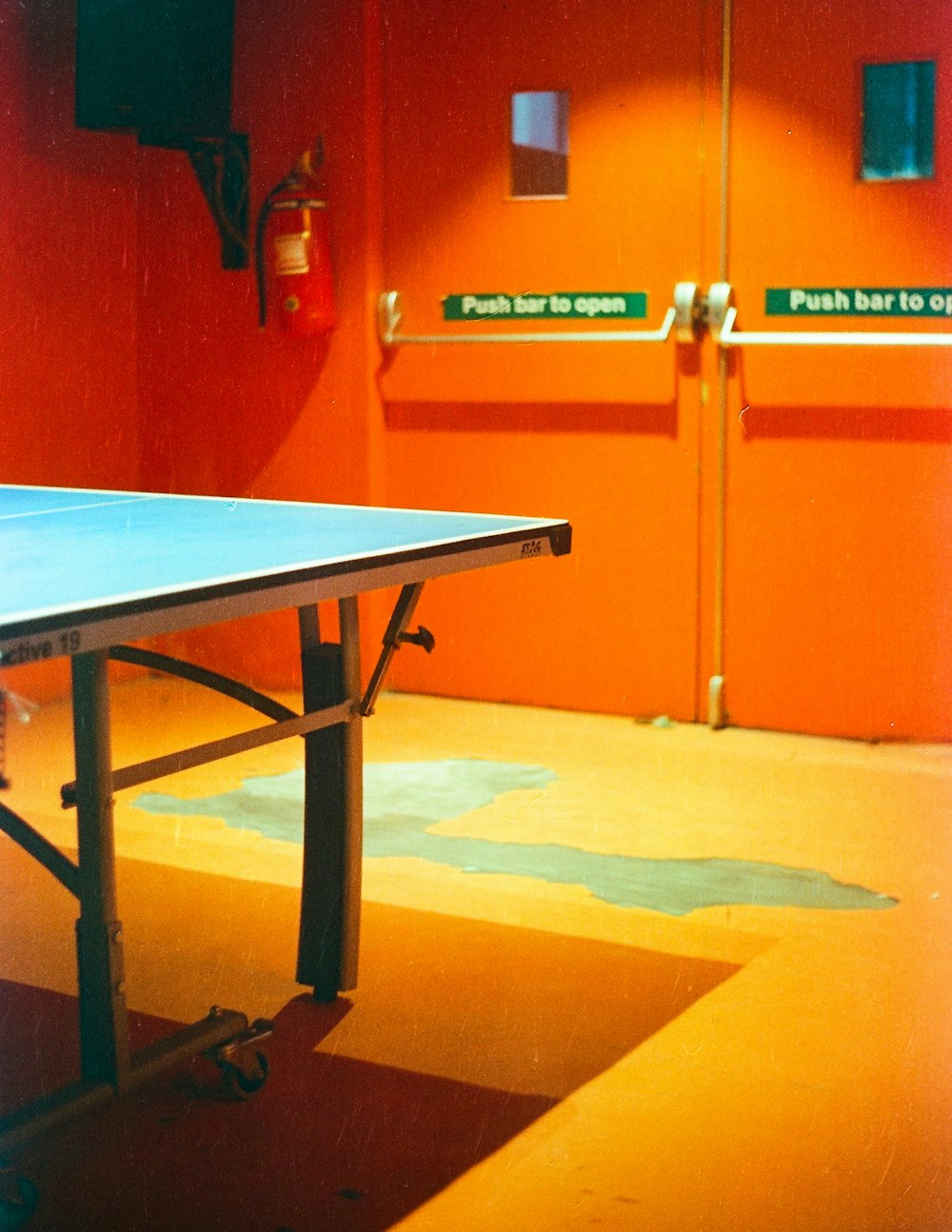 a ping pong table in a brightly lit room