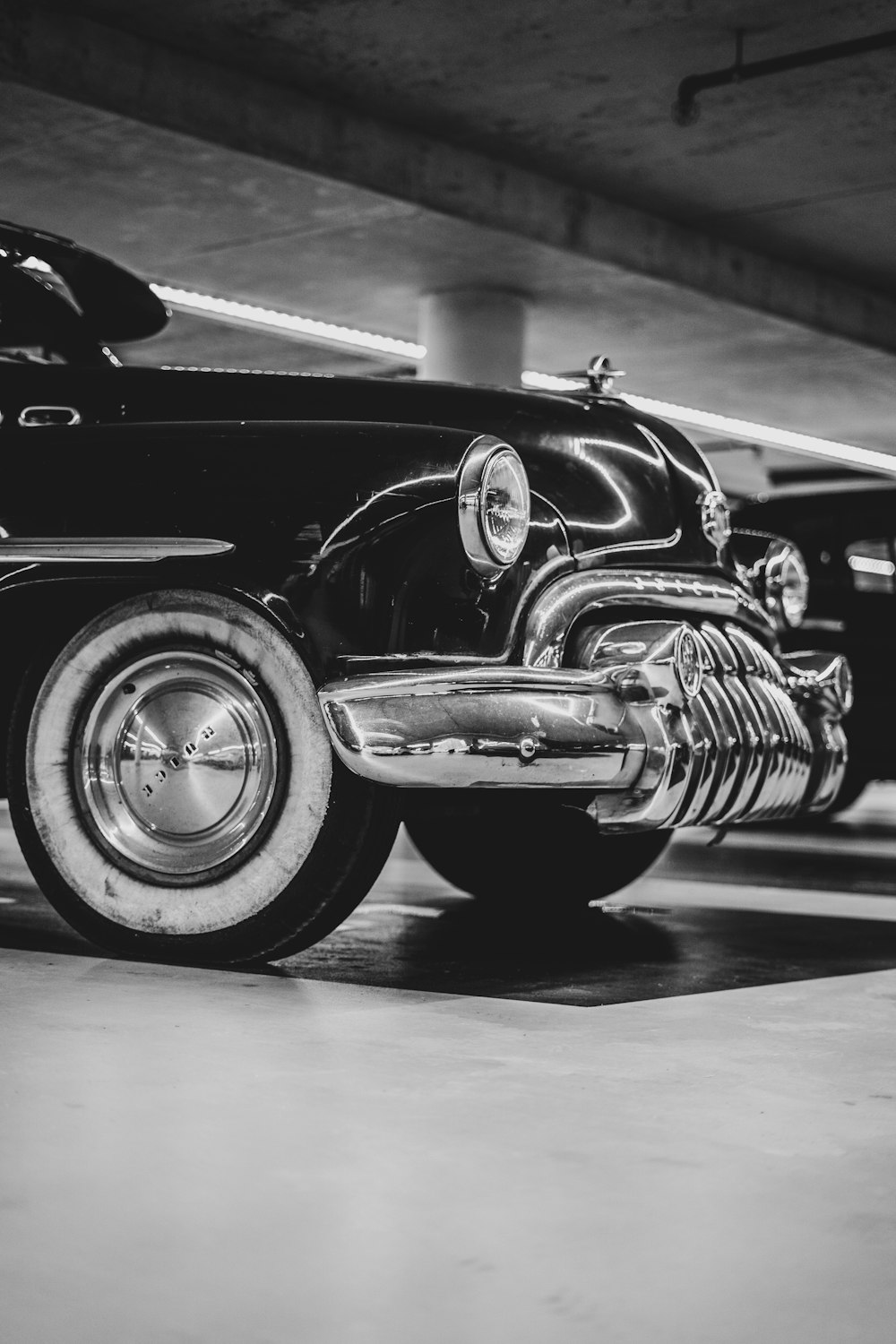 a black and white photo of a classic car