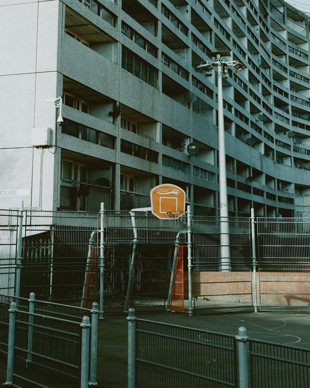 a basketball hoop in front of a tall building