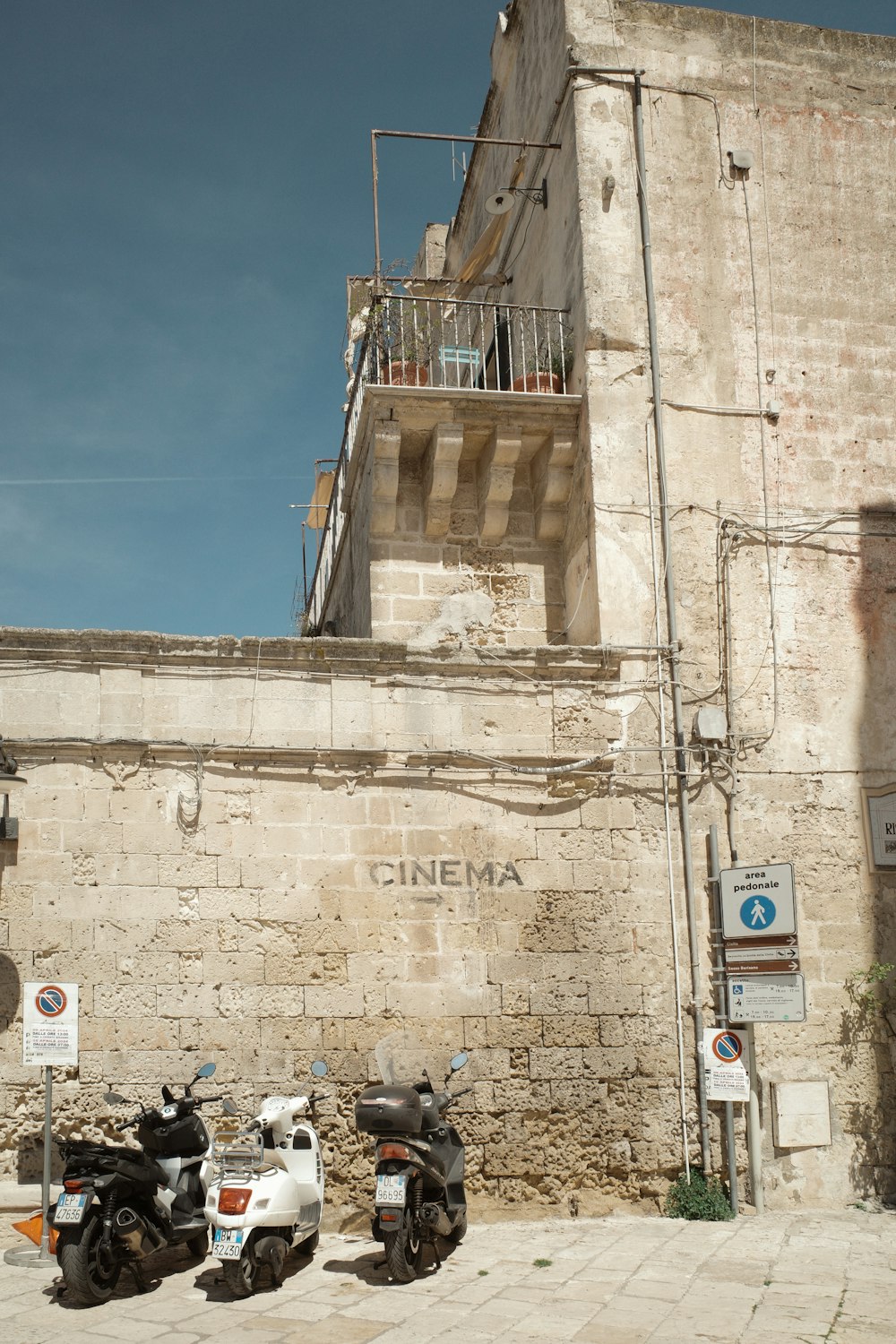 two motorcycles parked in front of a building