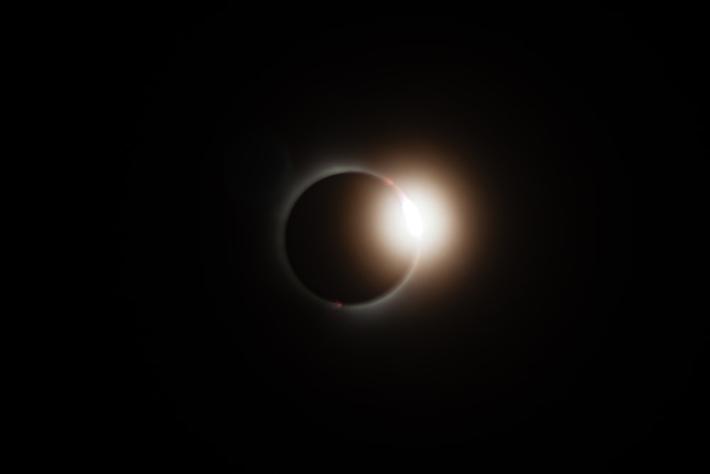 a solar eclipse seen through the dark sky