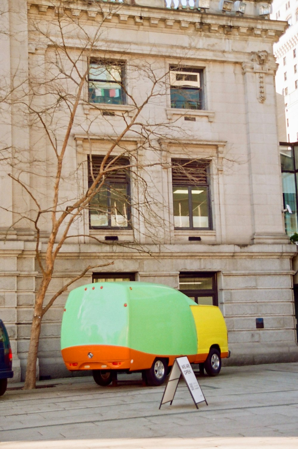 a truck parked in front of a tall building