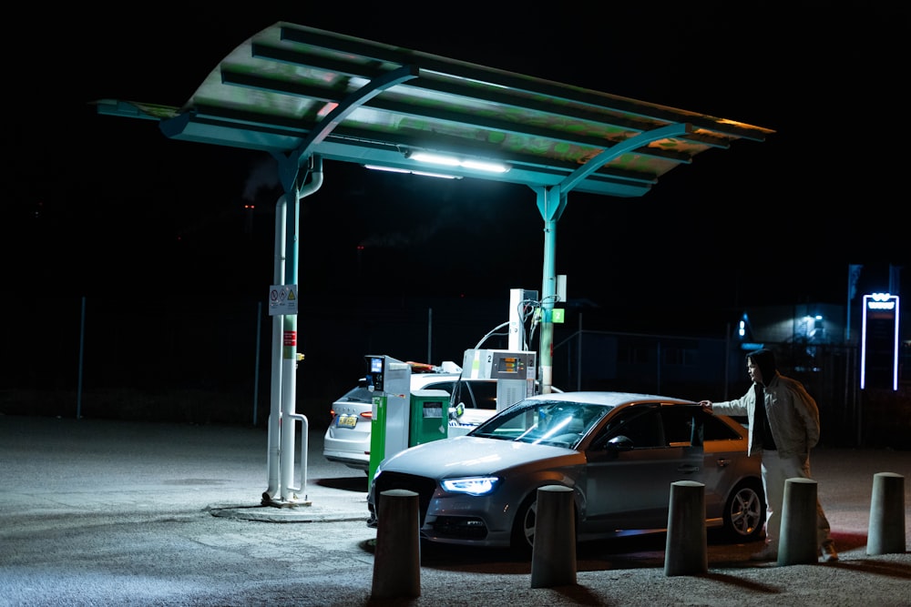 a car parked at a gas station at night