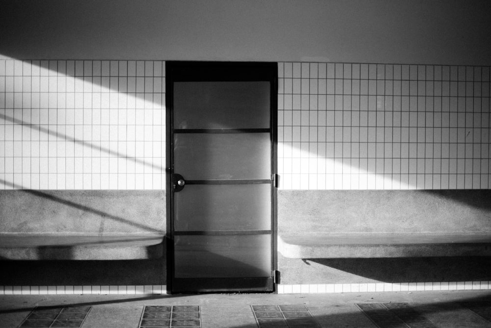 a black and white photo of a refrigerator in a room