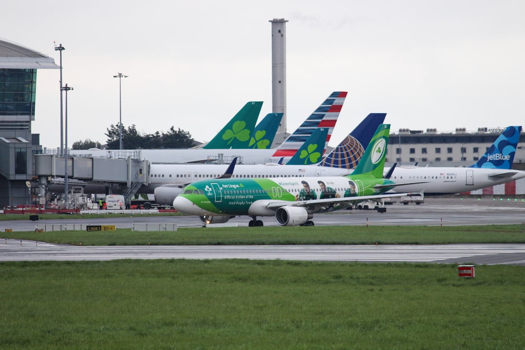 a group of airplanes that are sitting on a runway, Aer Lingus Airbus A320 taxing to RW28R