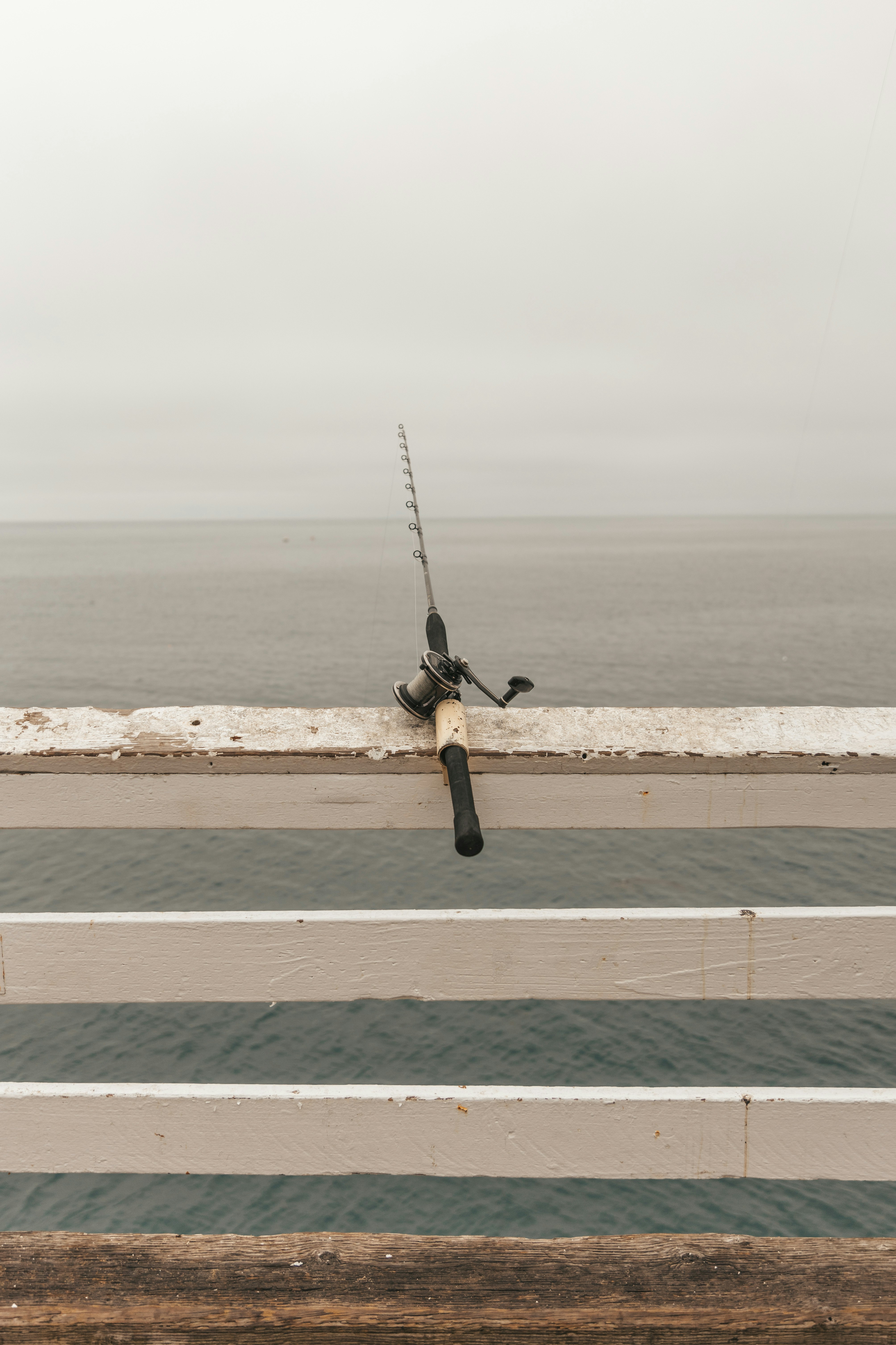 a fishing rod on the side of a bridge