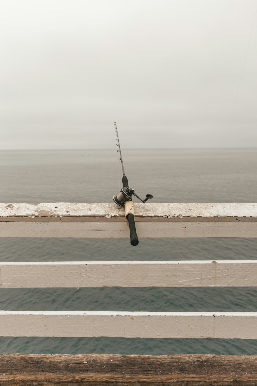 a fishing rod on the side of a bridge