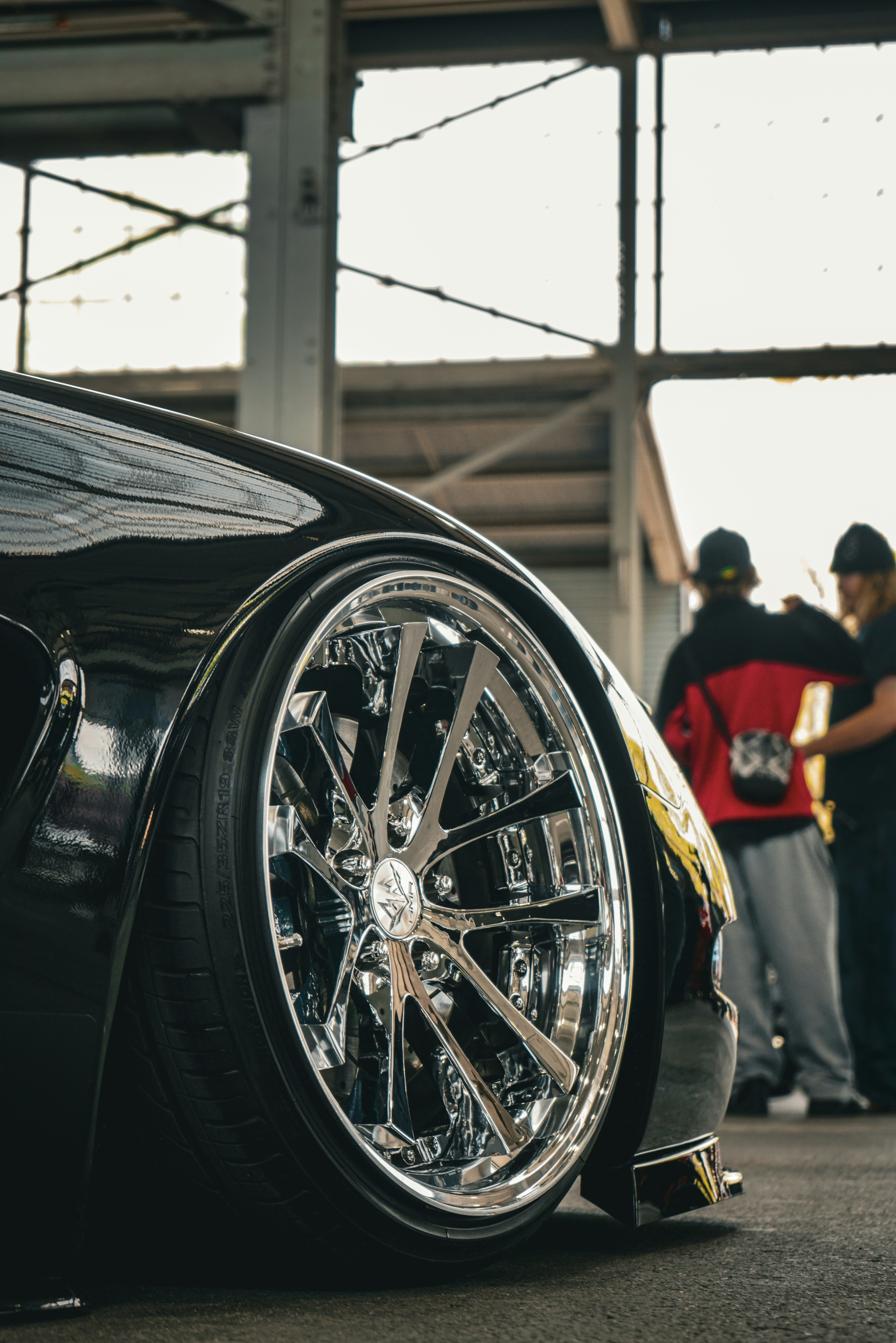 Close up of car wheel after deep clean, dark background, metallic chrome shining, dramatic lighting, dark atmosphere