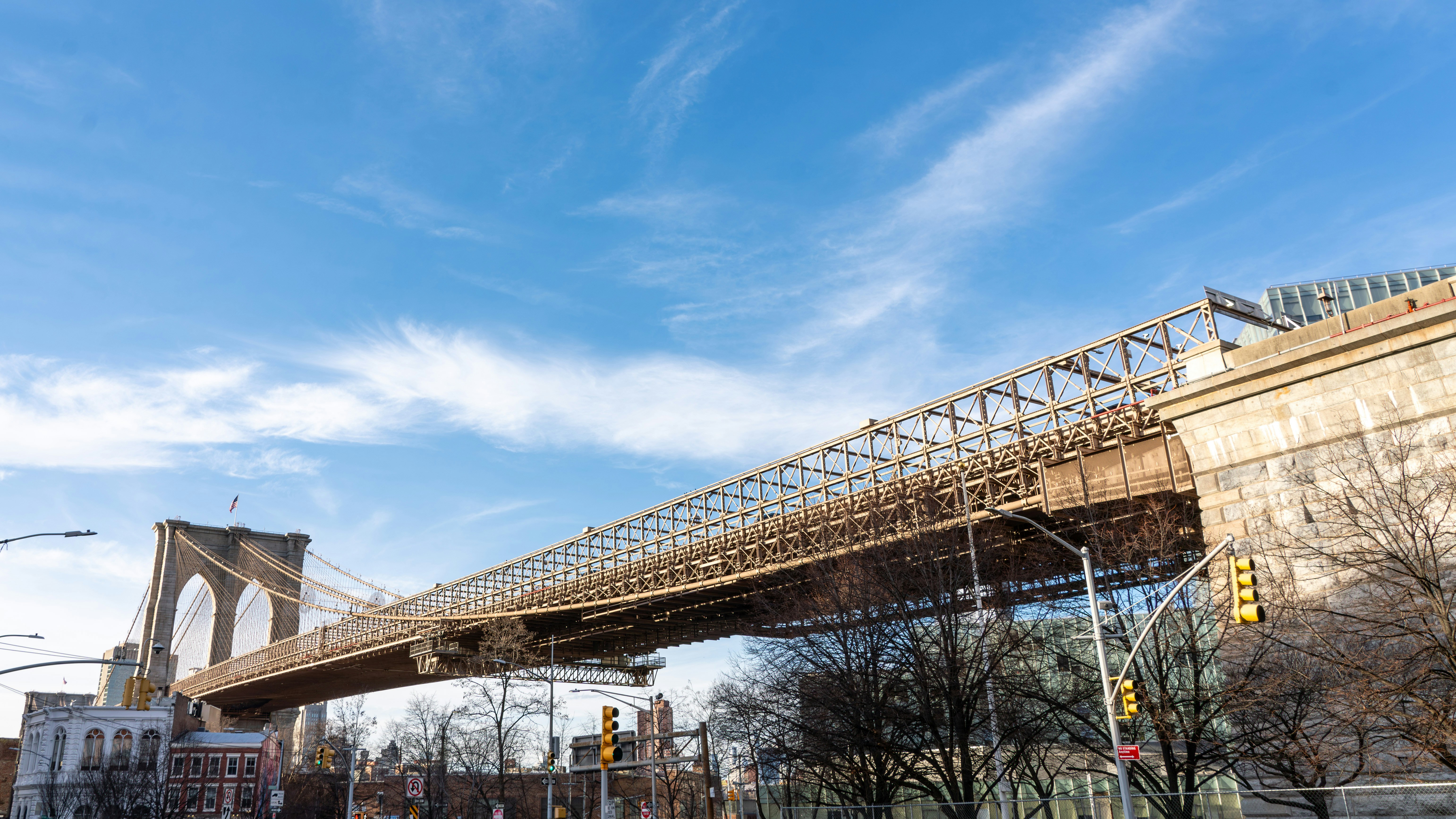 a bridge spanning over a city street next to tall buildings