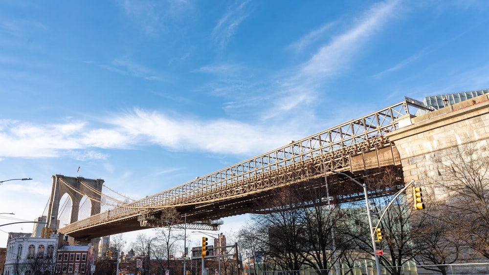 a bridge spanning over a city street next to tall buildings