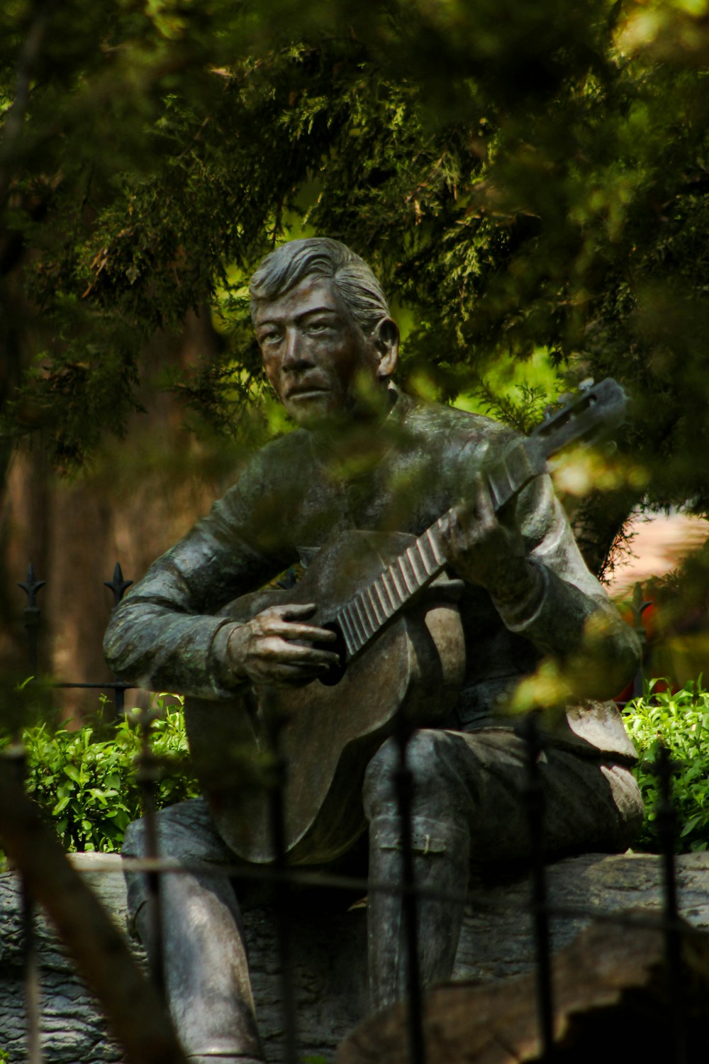 a statue of a man playing a guitar