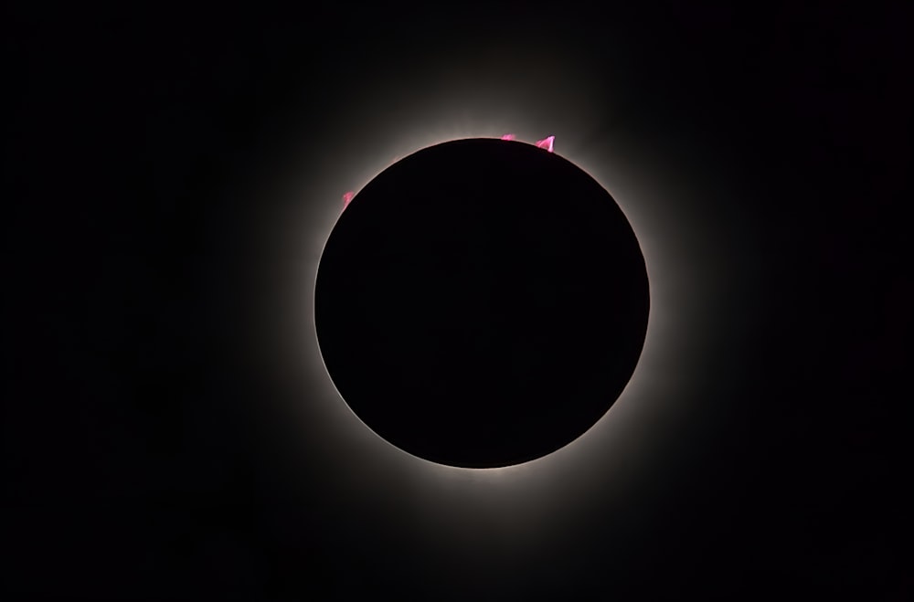 a solar eclipse is seen in the dark sky