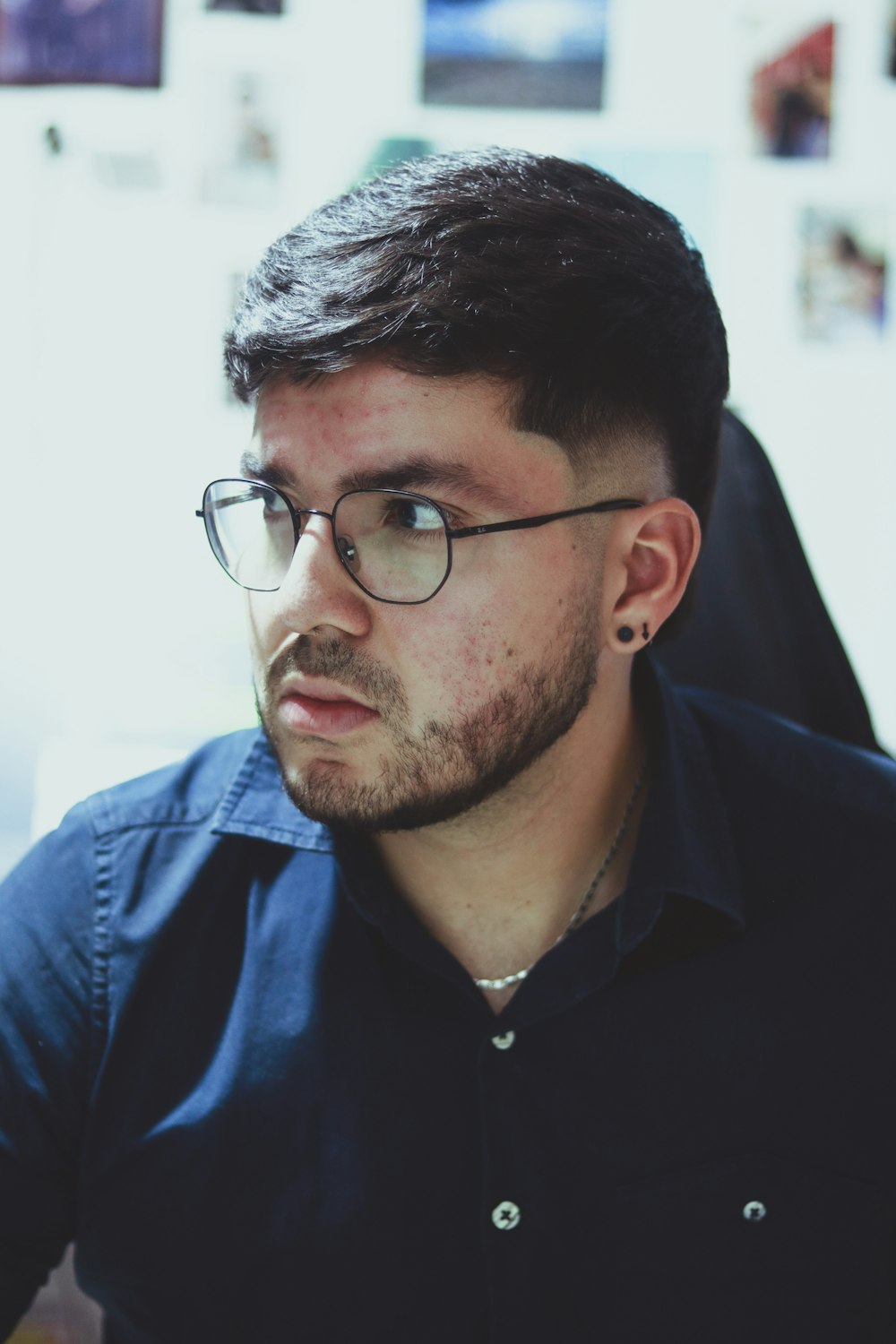 a man wearing glasses and a black shirt