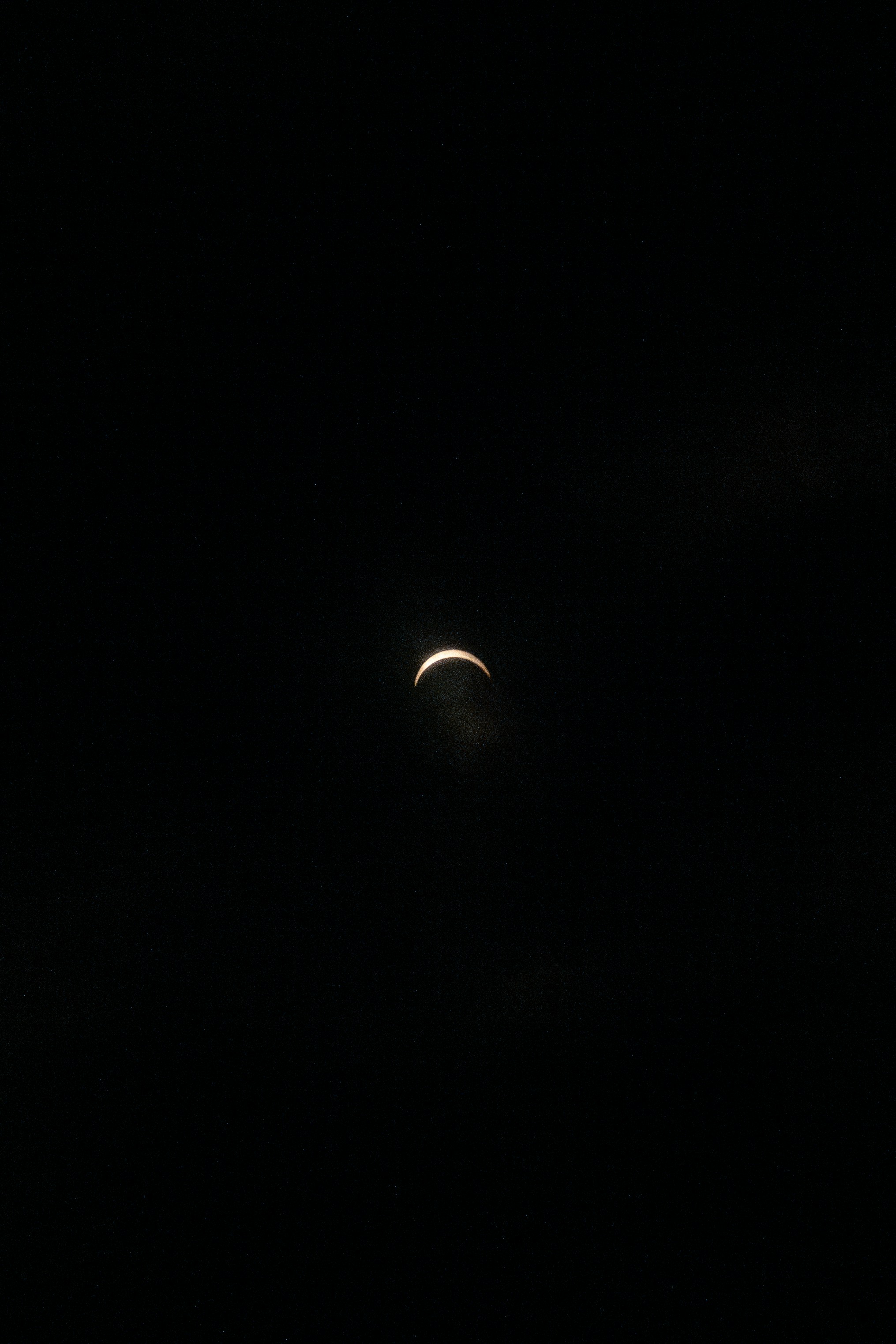 the moon is seen in the dark sky