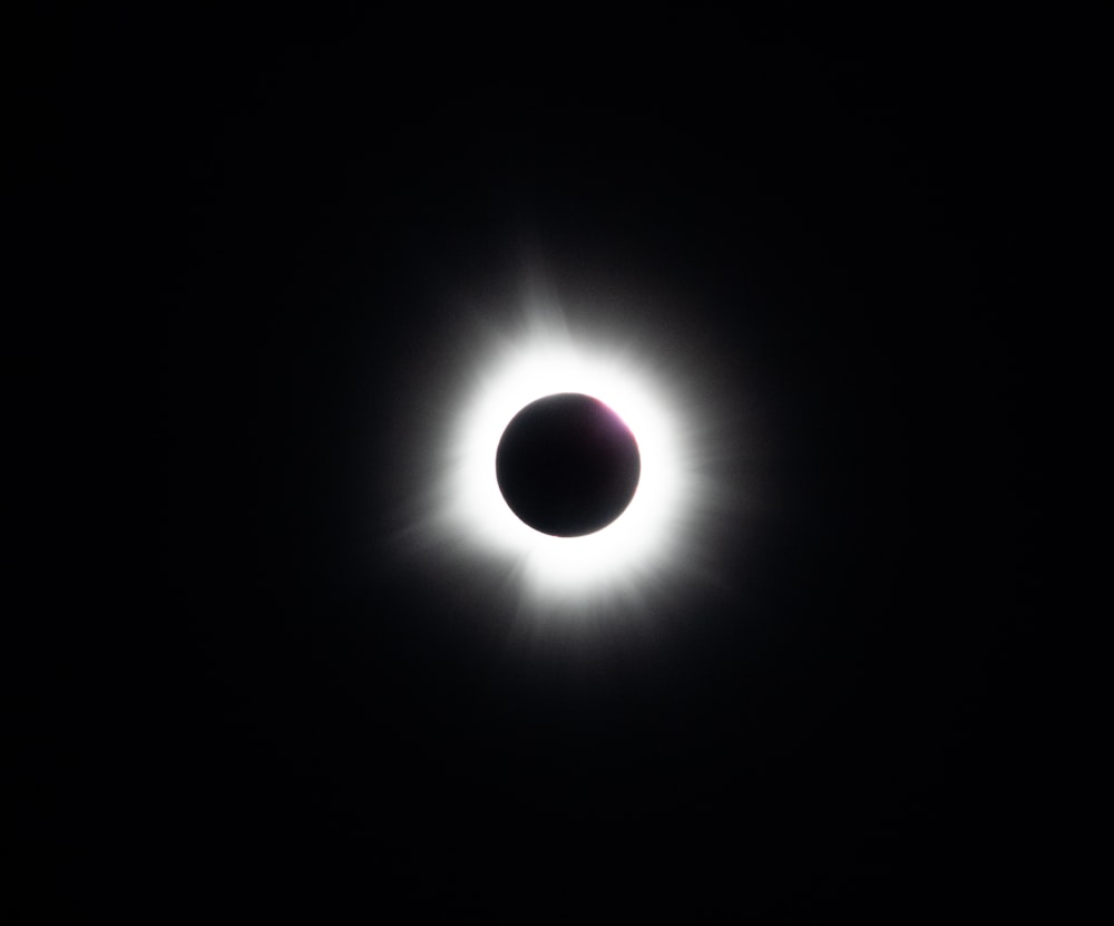 a solar eclipse is seen in the dark sky