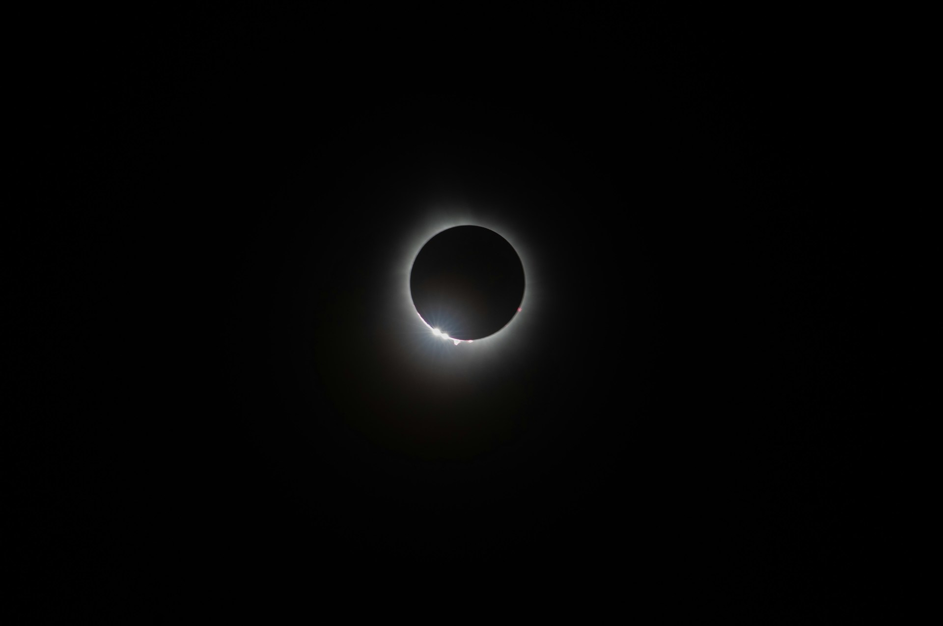 a solar eclipse is seen in the dark sky