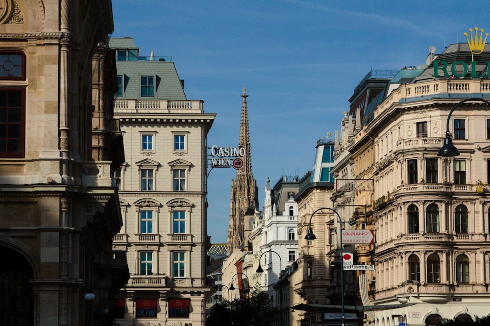 a city street lined with tall buildings and a clock tower