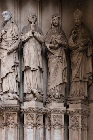 a group of statues on the side of a building