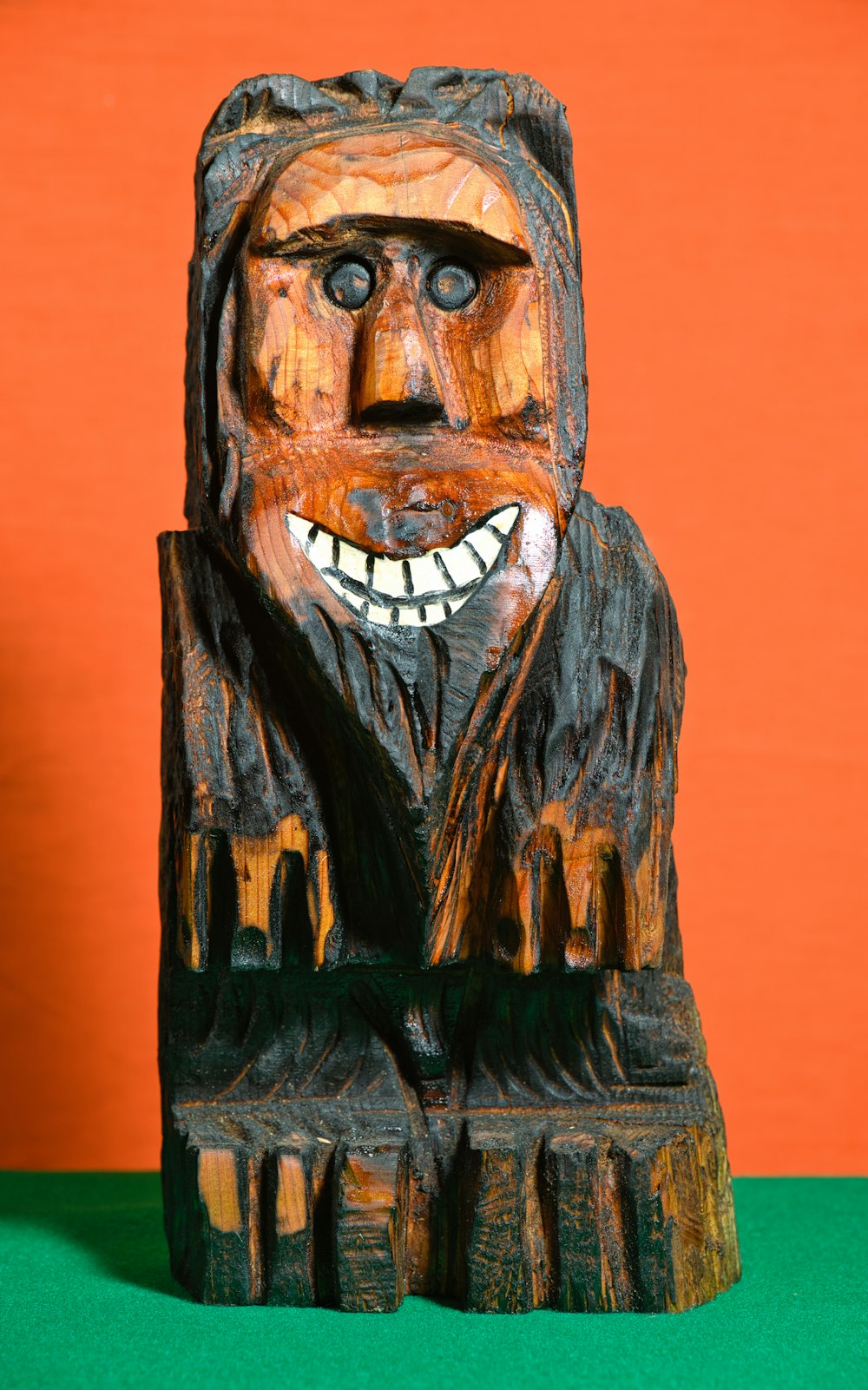 a wooden carving of a man with a smile on his face