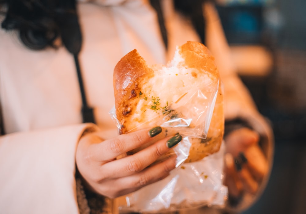 a close up of a person holding a bag of food