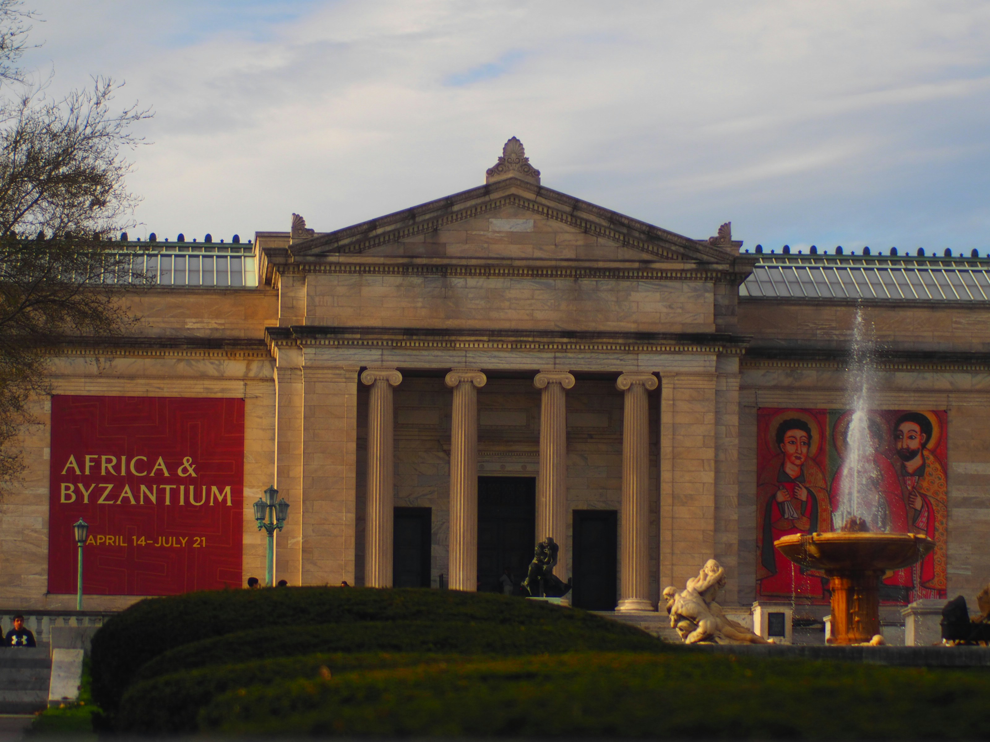 a large building with a fountain in front of it