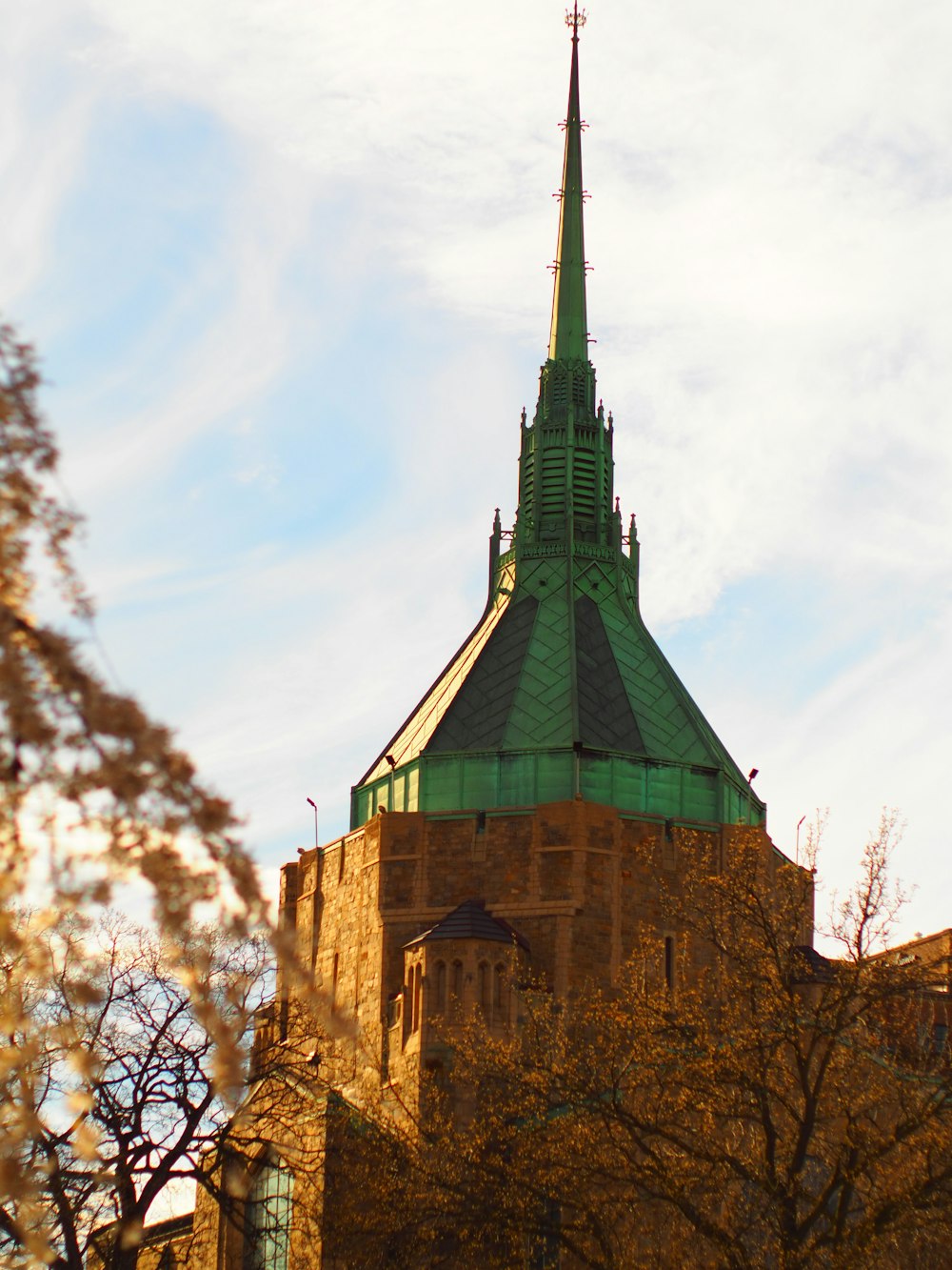 a tall building with a green steeple on top