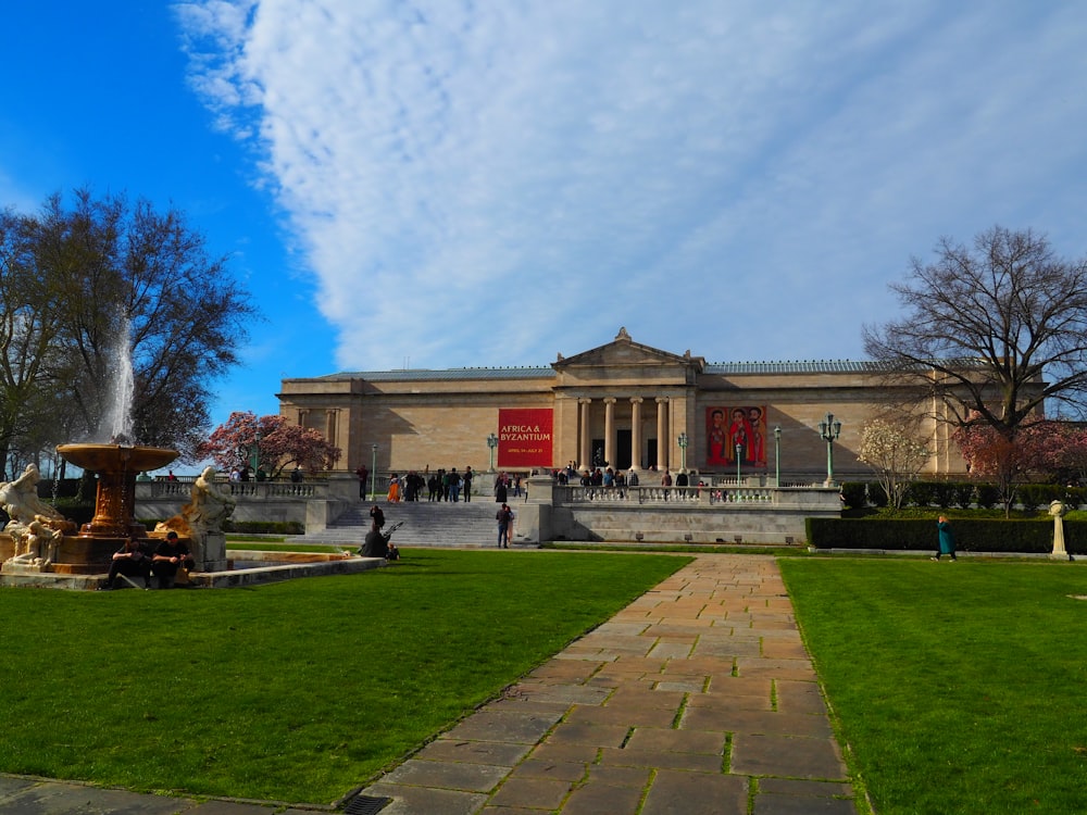 a large building with a fountain in front of it