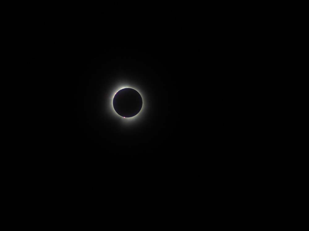 a solar eclipse is seen in the dark sky