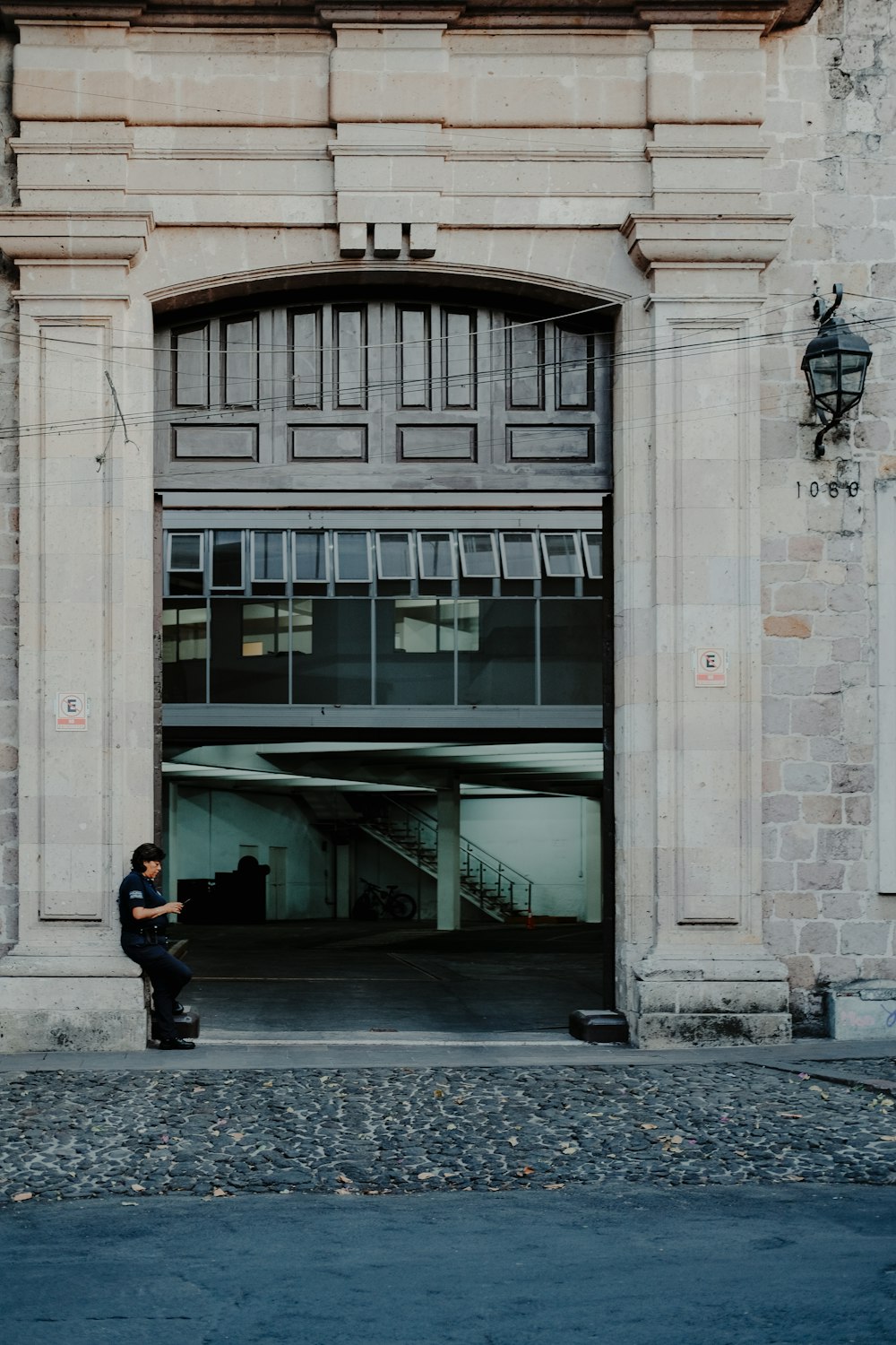 a man sitting on a skateboard in front of a building