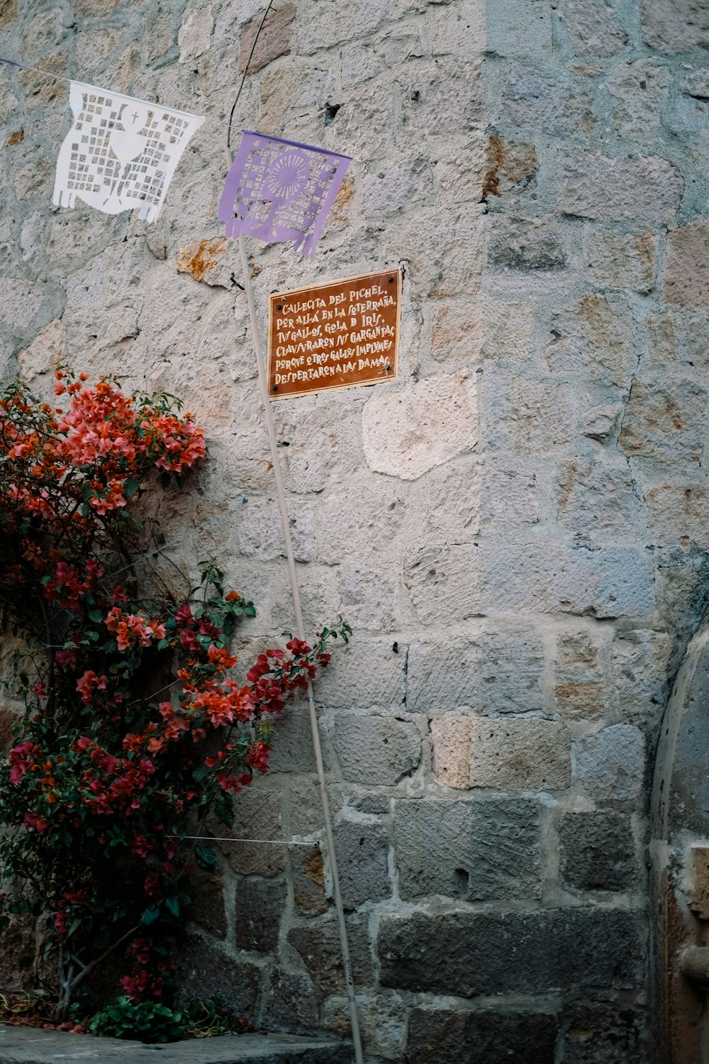 a stone building with a sign on the side of it