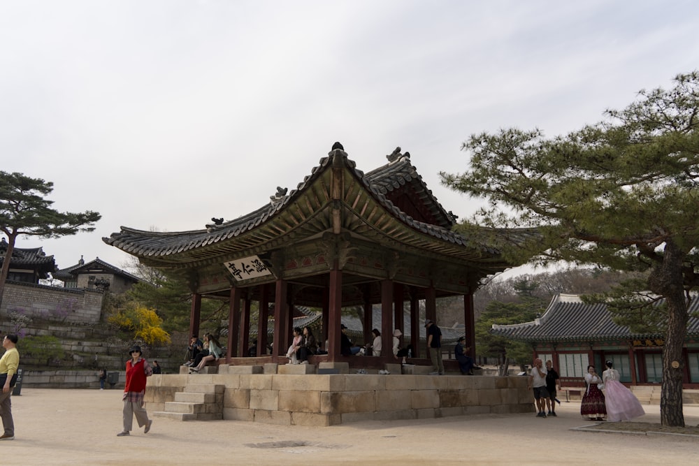 a group of people standing in front of a pavilion