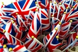 a bunch of british flags with gold pins sticking out of them