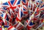 a bunch of british flags with gold pins sticking out of them