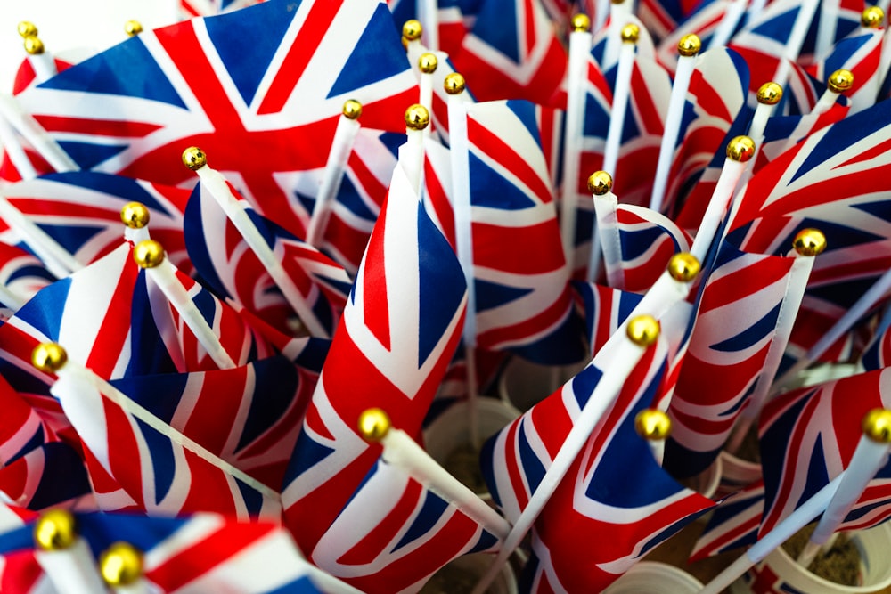 a bunch of british flags with gold pins sticking out of them