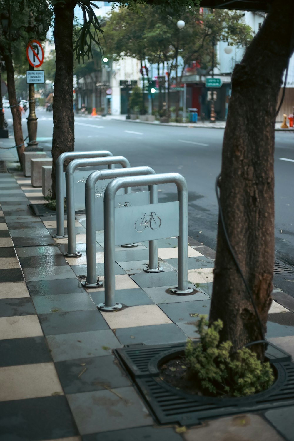 a row of bike racks on the side of a street