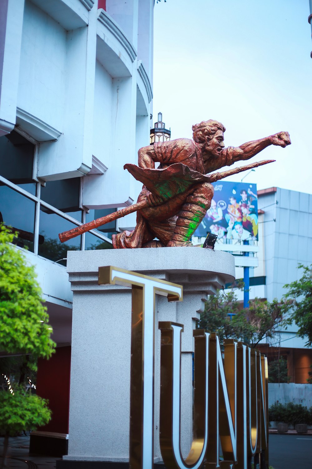 a statue of a man holding a baseball bat