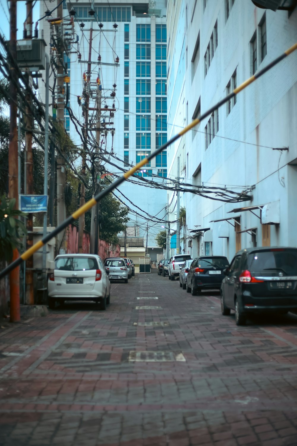 a city street filled with lots of traffic next to tall buildings