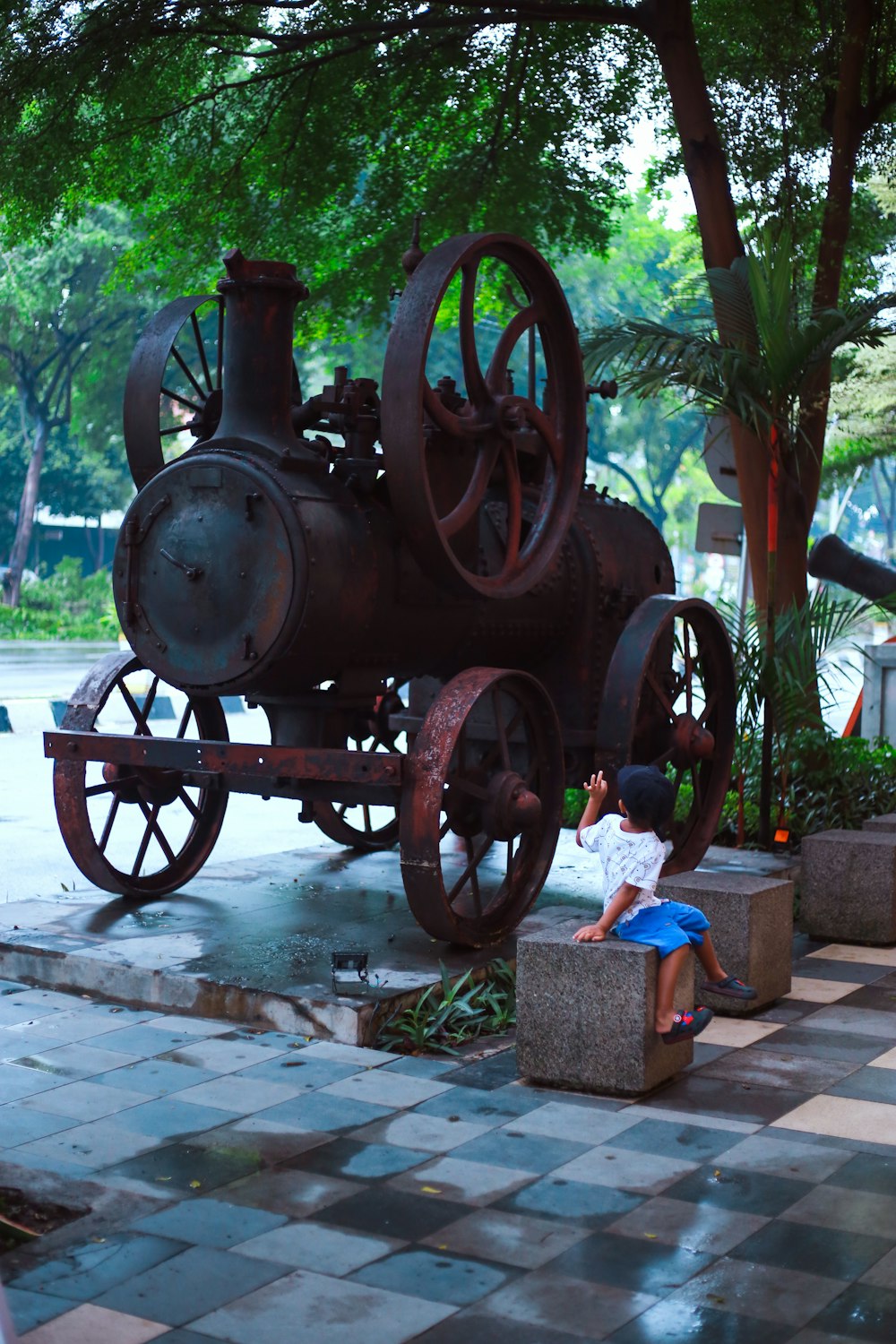 a man sitting on a bench next to an old train