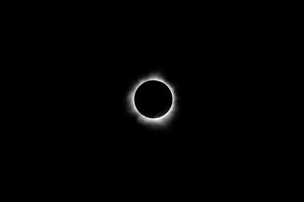 a solar eclipse is seen in the dark sky