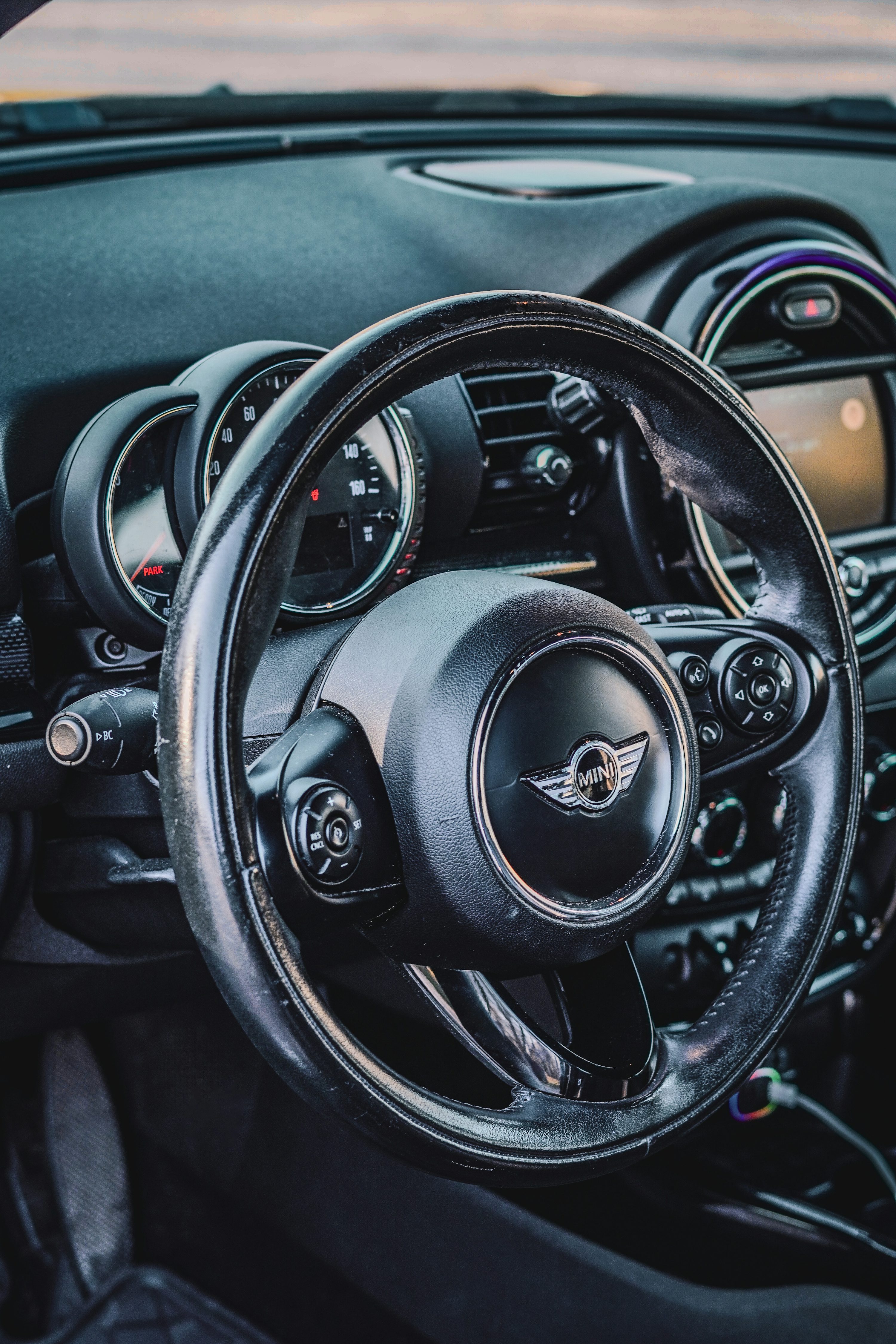 the interior of a car with a steering wheel and dashboard