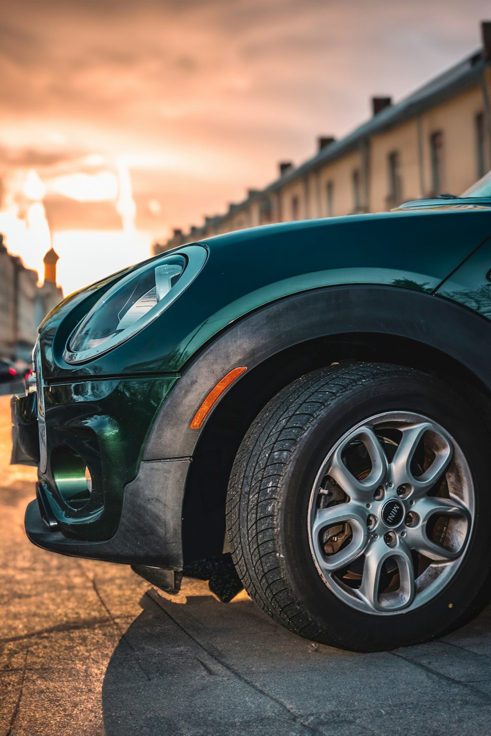 a green car parked on the side of the road