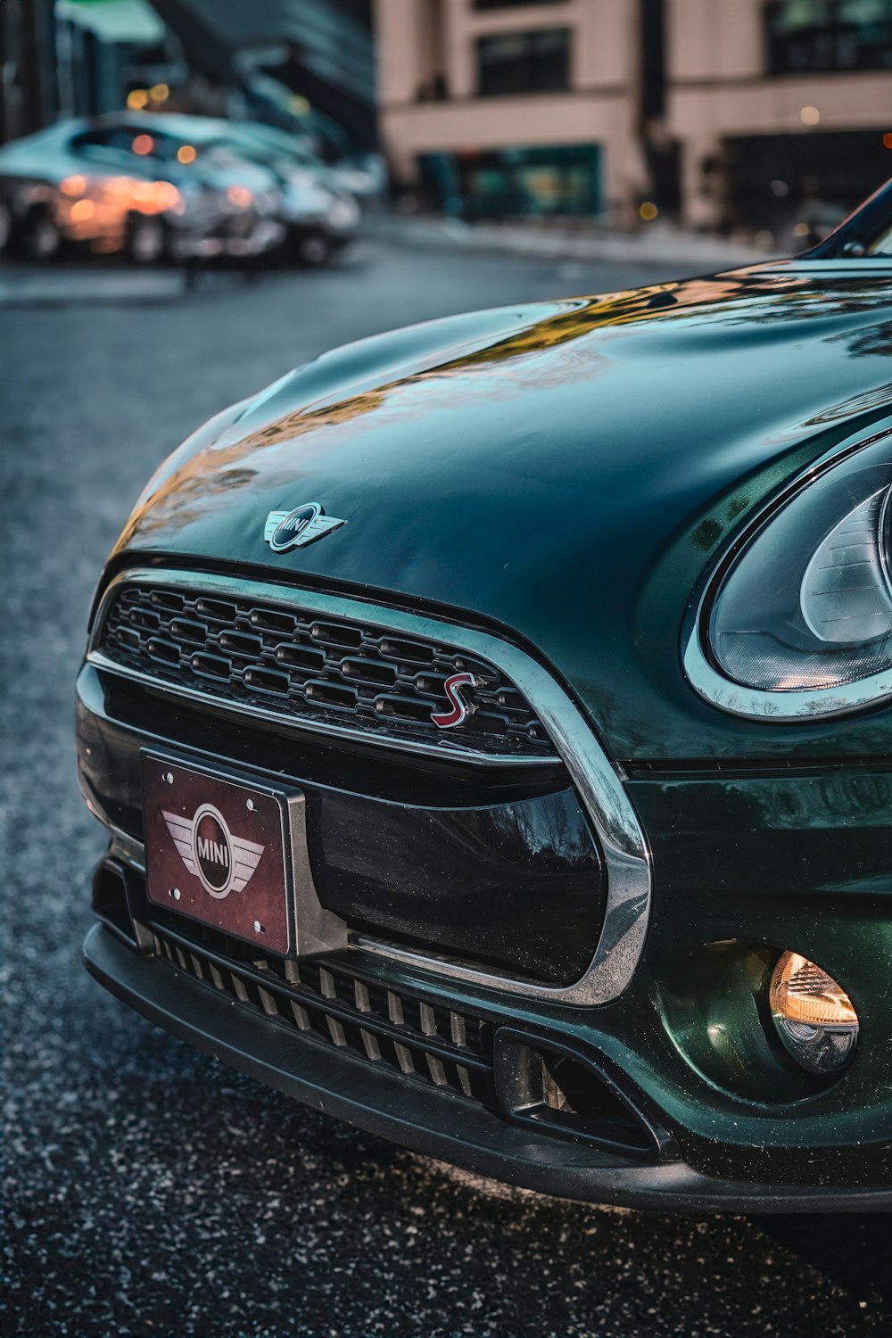 a green sports car parked on the side of the road