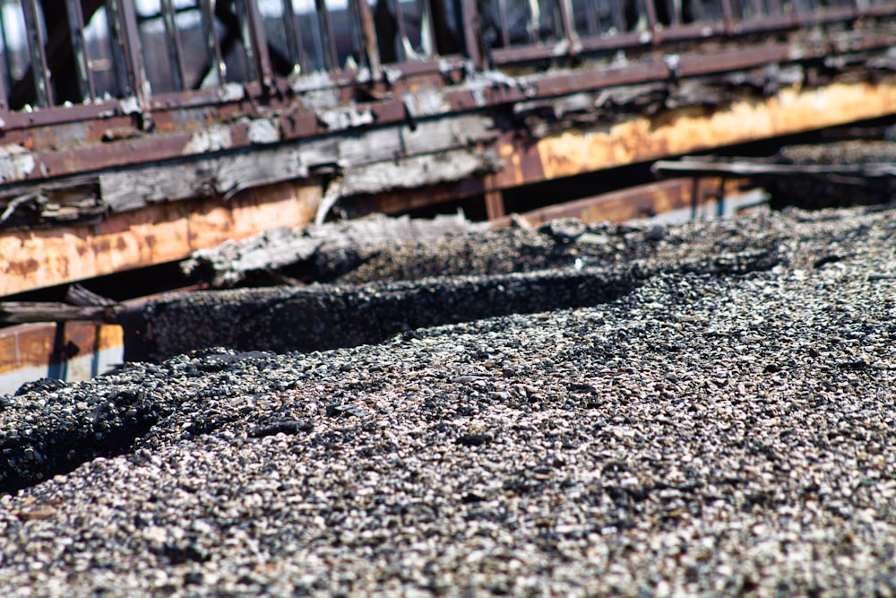 a train track with a rusted rail bridge in the background