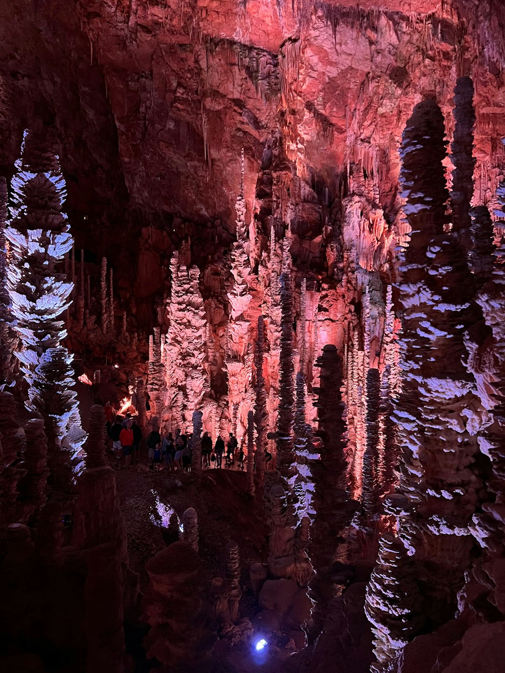 a group of people standing inside of a cave